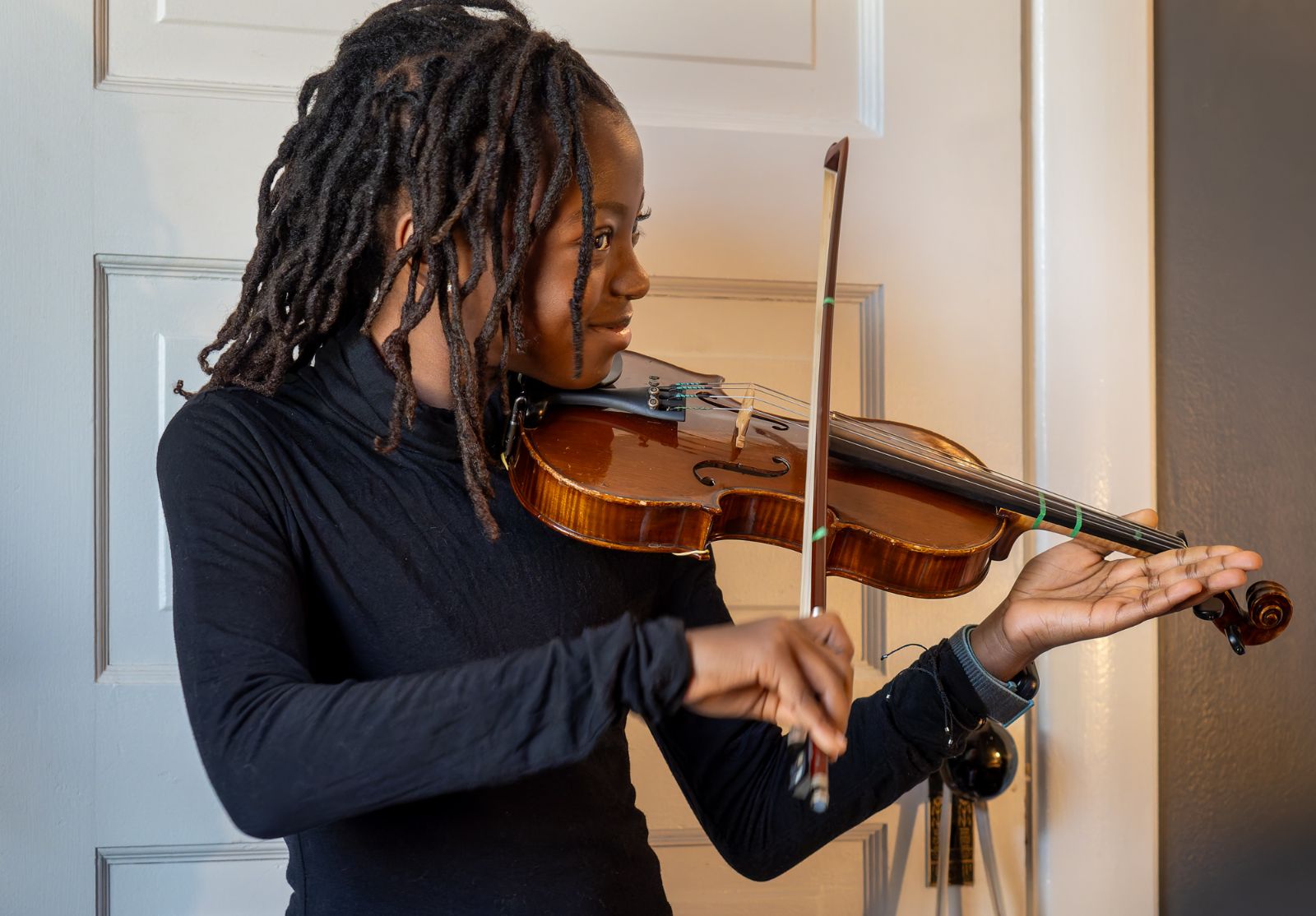 Fourth grade student practices violin.